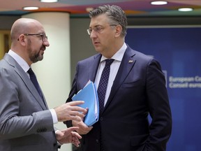 European Council President Charles Michel, left, speaks with Croatia's Prime Minister Andrej Plenkovic during a round table meeting at an EU summit in Brussels, Friday, June 24, 2022. EU leaders were set to discuss economic topics at their summit in Brussels Friday amid inflation, high energy prices and a cost of living crisis.