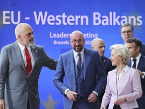 From left, Albanian Prime Minister Edi Rama, European Council President Charles Michel, North Macedonia's Prime Minister Dimitar Kovacevski, European Commission President Ursula von der Leyen, Serbian President Aleksandar Vucic and French President Emmanuel Macron walk to a group photo during an EU summit in Brussels, Thursday, June 23, 2022. European Union leaders are expected to approve Thursday a proposal to grant Ukraine a EU candidate status, a first step on the long toward membership. The stalled enlargement process to include Western Balkans countries in the bloc is also on their agenda at the summit in Brussels.