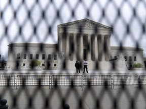 FILE - The U.S. Supreme Court is seen behind a fence who stands around the building on Thursday, May 5, 2022 in Washington. One proposal pending in Congress would provide additional security measures for the justices and another would offer more privacy and protection for all federal judges.