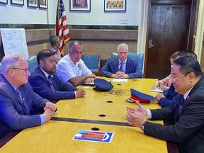 In this photo provided by Office of Philippine Consul-General Elmer Cato, Philippine Consul-General Elmer Cato, right, talks with Philadelphia Mayor Jim Kenney, left, at the Philadelphia City hall, PA., on Tuesday June 21, 2022. The mayor of Philadelphia expressed shock and sorrow over the killing of a Filipino lawyer who was shot in the city over the weekend and is offering a $20,000 reward for information that will lead to the arrest of the shooter, Cato said Wednesday. (Office of Philippine Consul-General Elmer Cato via AP)