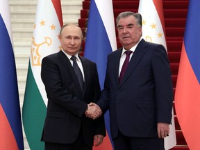 Russian President Vladimir Putin, left, and Tajikistan's President Emomali Rakhmon pose for a photo during their meeting in Dushanbe, Tajikistan, Tuesday, June 28, 2022.