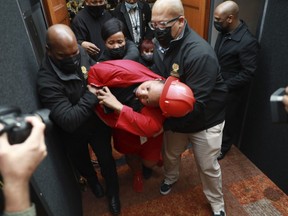 A members of the opposition, Economic Freedom Fighters (EFF) party is ejected from parliament in Cape Town, South Africa, Thursday, June 9, 2022 for disrupting proceedings. South African President Cyril Ramaphosa is facing the biggest challenge to his presidency and is expected to face calls from opposition lawmakers to step down pending a criminal investigation into allegations that he tried to cover up the theft of $4 million from his game farm in the northern Limpopo province.