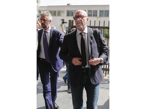 Canadian-born film director Paul Haggis, right, arrives with his lawyer Federico Straziota at Brindisi law court in southern Italy, Wednesday, June 22, 2022, to be heard by prosecutors investigating a woman's allegations he had sex with her without her consent over the course of two days. Under Italian law, a judge, after hearing arguments from both prosecutors and defense lawyers, will rule on whether Haggis can be set free pending possible additional investigation.