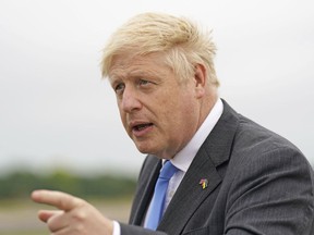 Britain's Prime Minister Boris Johnson gestures after arriving at RAF Brize Norton, in Oxfordshire, England, Saturday, June 18, 2022, following a trip to Ukraine. Johnson met with President Volodymyr Zelenskyy in Kyiv to offer continued aid and military training.