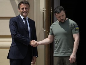 French President Emmanuel Macron, left, shakes hands with Ukrainian President Volodymyr Zelenskyy in Kyiv, Thursday, June 16, 2022, as the leaders of France, Italy, Germany and Romania made a high-profile visit to Ukraine.
