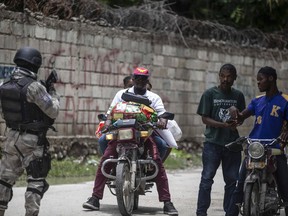 A police officer patrols a street during an anti-gang operation in Croix-des-Missions, north of Port-au-Prince, Haiti, Thursday, April 28, 2022. Haiti's understaffed and under-resourced police department is roughly made up of 11,000 officers for a country of more than 11 million people.