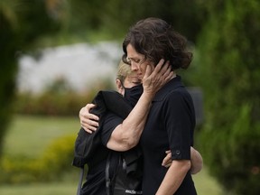 Alessandra Sampaio, right, is comforted during the funeral of her husband British journalist Dom Phillips at the Parque da Colina cemetery in Niteroi, Brazil, Sunday, June 26, 2022. Family and friends paid their final respects to Phillips who was killed in the Amazon region along with the Indigenous expert Bruno Pereira.