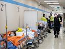 Paramedics transfer patients to the emergency room, but have no choice but to leave them in the hallway due to an at-capacity ER at Humber River Hospital in Toronto, on Jan.  25.