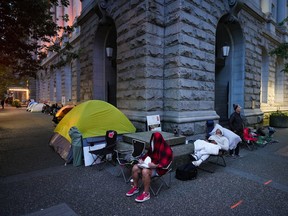 People camp out overnight outside a Service Canada passport office in Vancouver, on June 22.