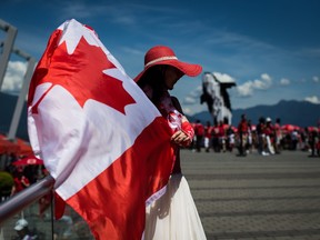 Summer Shen waves a Canadian flag while sporting a patriotic outfit during Canada Day celebrations in Vancouver, on July 1, 2019.