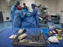 Sterile instruments are laid out as a male patient is prepped to have a cyst removed from his right knee at the Cambie Surgery Centre, in Vancouver on Wednesday, August 31, 2016. 