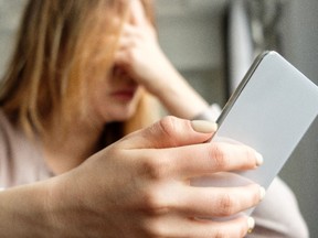 Upset girl with a phone. Getty Images/iStockphoto