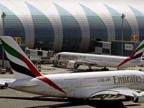 Air Canada and Emirates have signed a strategic partnership agreement and plan to establish a code-share relationship later this year. Emirates passenger planes are in use at Dubai airport in United Arab Emirates in this May 8, 2014 file photo.THE CANADIAN PRESS/AP-Kamran Jebreili