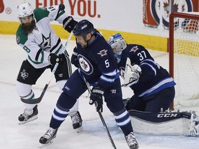 Dallas Stars' Patrick Eaves' (18) deflection goes high and wide of Winnipeg Jets goaltender Connor Hellebuyck (37) as Mark Stuart (5) defends during first period NHL hockey action in Winnipeg on Thursday, October 27, 2016. The Edmonton Oilers have added Stuart, the former NHL defenceman to its coaching staff for the upcoming season.THE CANADIAN PRESS/John Woods