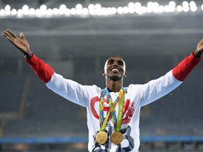 Gold medallist Britain's Mo Farah celebrates on the podium for the Men's 5000m during the athletics event at the Rio 2016 Olympic Games at the Olympic Stadium in Rio de Janeiro on August 20, 2016.