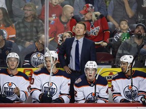 Edmonton Oilers' assistant coach Glen Gulutzan looks to the scoreboard during first period preseason NHL hockey action in Calgary, Monday, Sept. 17, 2018. The Oilers say assistant coaches Gulutzan and Dave Manson will return next season as the NHL team shored up its hockey operations staff on Thursday.