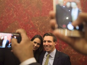 Brampton Mayor Patrick Brown poses for a photo for a supporter alongside his wife Genevieve Gualtieri after winning the Brampton Mayoral Election, in Brampton, Ont., Monday, Oct. 22, 2018.