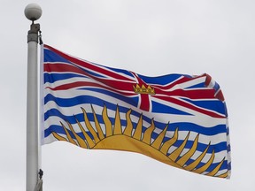 British Columbia's provincial flag flies on a flag pole in Ottawa, Friday July 3, 2020. A Quebec man who fell and broke multiple bones in his face during a trip to Sun Peaks in British Columbia says his surgery was cancelled after he was told his home province would not pay for it.