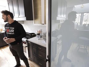 In this Tuesday, April 2, 2019, photo, former NHL player Daniel Carcillo is reflected in a pantry door as he grabs a cappuccino at his rural home in Homer Glen, Ill. Carcillo is angry about the testimony of Canadian hockey officials at a parliamentary hearing looking into the handling of recent assault allegations.