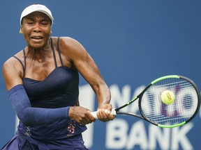 Venus Williams of the USA returns a shot to Carla Suarez Navarro of Spain during round 1 of the Rogers Cup Women's tennis tournament in Toronto, Tuesday August 6, 2019.&ampnbsp;Venus Williams has been given a wildcard into the main draw of the National Bank Open.
