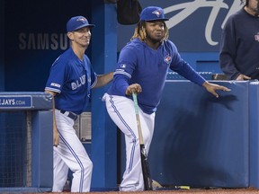 Toronto Blue Jays' Vladimir Guerrero Jr., right, pretends to coach with first base coach Mark Budzinski in the sixth inning of their American League MLB baseball game against the Tampa Bay Rays in Toronto on September 28, 2019.