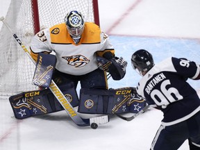 Nashville Predators goaltender David Rittich, back, makes a stick save on a shot by Colorado Avalanche right wing Mikko Rantanen during the shootout of an NHL hockey game Thursday, April 28, 2022, in Denver. The Jets have signed David Rittich to a one-year, US$900,000 contract to back up star goaltender Connor Hellebuyck.&ampnbsp;THE CANADIAN PRESS/AP/David Zalubowski