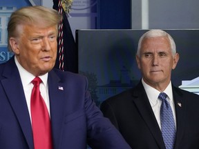 Two of the central characters in America's January 6 drama are back in the national capital -- both of them with presidential ambitions. Vice President Mike Pence, right, listens as President Donald Trump, left, makes a statement from the briefing room at the White House in Washington, Tuesday, Nov. 24, 2020.