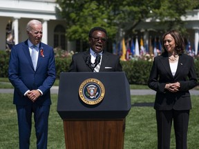 President Joe Biden and Vice President Kamala Harris listen as Garnell Whitfield Jr., who lost his mother Ruth Whitfield in the Tops market mass shooting in Buffalo, speaks during an event to celebrate the passage of the "Bipartisan Safer Communities Act," on the South Lawn of the White House, Monday, July 11, 2022, in Washington.