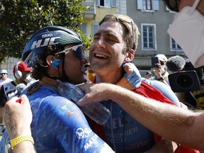 Stage winner Canada's Hugo Houle, right, is congratulted by teammate Canada's Michael Woods, after the sixteenth stage of the Tour de France cycling race over 178.5 km on Tuesday.