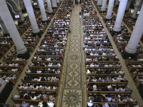 A congregation gathers in Sainte-Anne-de-Beaupre Basilica, northeast of Quebec City, on August 15, 2010. The first Quebec mass amid Pope Francis's weeklong trip to Canada to make amend with First Nations, Métis and Inuit communities is set to take place in the renowned pilgrimage site that merges Indigenous culture and Catholicism.