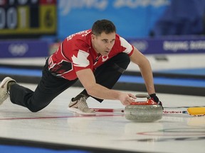 John Morris, of Canada, throws a rock during the mixed doubles curling match against the Czech Republic at the Beijing Winter Olympics, in Beijing, Monday, Feb. 7, 2022. Morris and Shannon Birchard have joined forces in mixed doubles curling.