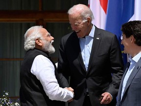 Canada's Prime Minister Justin Trudeau (R) looks on as US President Joe Biden (C) greets India's Prime Minister Narendra Modi (L) as they arrive to attend the outreach program on June 27, 2022 at Elmau Castle, southern Germany, where the German Chancellor hosts a summit of the Group of Seven rich nations (G7).
