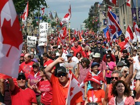 Hundreds of "Freedom Convoy" supporters march in downtown Ottawa on Canada Day July 1, 2022 in Ottawa, Canada.