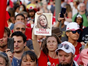 A woman holds a photograph of Tamara Lich, one of the main organizers of the Freedom Convoy, as a protest against COVID-19 mandates takes place in Ottawa on Canada Day, July 1, 2022.