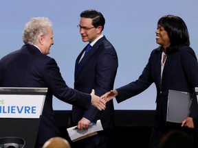 From left, Conservative Party of Canada leadership hopefuls Jean Charest, Pierre Poilievre and Leslyn Lewis take part in a debate in Ottawa, on May 5.