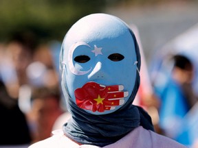 An ethnic Uyghur demonstrator wearing a mask takes part in a protest against China near the Chinese consulate in Istanbul, Turkey July 5, 2022. REUTERS/Murad Sezer