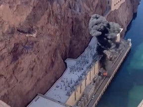 Unconfirmed social media video shows a small explosion and smoke and fire coming from the base of the dam.