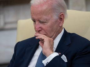 U.S. President Joe Biden listens to Mexican President Andres Manuel Lopez Obrador as they talk to journalists in the Oval Office on July 12, 2022.  Biden’s approval rating now sits at 33 per cent, and 64 per cent of Democrats say they want a new presidential candidate in time for the next election, writes Sabrina Maddeaux.