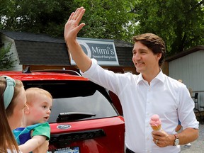 Prime Minister Justin Trudeau waves after buying ice cream at a snack stand in Ottawa on July 13, 2022. The Trudeau government seems divorced from the concerns of regular Canadians, writes Rex Murphy.