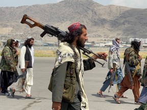 FILE PHOTO: Taliban forces patrol at a runway a day after U.S troops withdrawal from Hamid Karzai International Airport in Kabul, Afghanistan August 31, 2021.