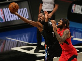 Brooklyn Nets forward Kevin Durant 
tries to keep a ball in bounds against Toronto Raptors forward DeAndre' Bembry on Feb. 5, 2021.
