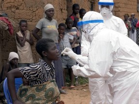 Dr. Mark Katz, a member of the World Health Organization (WHO), taking an oral sample from Feliciana, a patient suspected of having Marburg hemorrhagic fever, in Kinguangua, near Ui. Feliciana's grandmother, sister and ex-husband died of Marburg hemorrhagic fever. The young woman tested negative after being taken to Uighe Regional Hospital for observation.