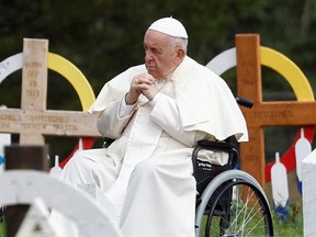 Pope Francis takes a moment for silent prayer at the cemetery during his meeting with First Nations, Metis and Inuit Indigenous communities in Maskwacis, Alberta, July 25, 2022.