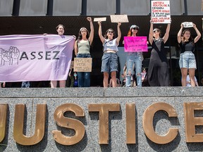 People protest the conditional discharge of a man who pleaded guilty to sexual assault, in Montreal on July 10, 2022.
