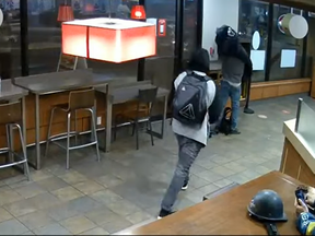 Assailant David Morin (with backpack) just moments before he begins viciously stabbing a random victim at a Vancouver Tim Hortons. Morin, who had a lengthy history of violent assaults (including raping a woman at axepoint), was sentenced to just three years in jail for the attack.