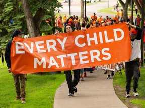 Participants march in the Every Child Matters - Healing March that began at the Alberta Legislature in Edmonton, on Friday, July 1, 2022.