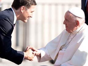 Prime Minister Justin Trudeau greets Pope Francis as he arrives at the Citadelle de Québec in Quebec City on July 27, 2022.