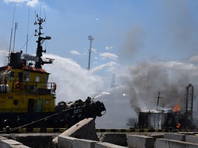 Firefighters work at a site of a Russian missile strike in a sea port of Odesa, Ukraine, on July 23.