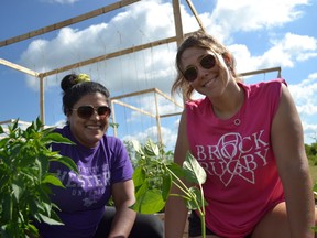 Amanda Ali, food security project co-ordinator at United Way Niagara (left) and United Nations Intern Jordyn Pitt at a local community garden.