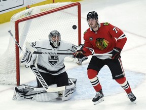 Los Angeles Kings goaltender Jonathan Quick (32) and Chicago Blackhawks center Kirby Dach (77) watch the puck during the third period of an NHL hockey game Tuesday, April 12, 2022, in Chicago.
